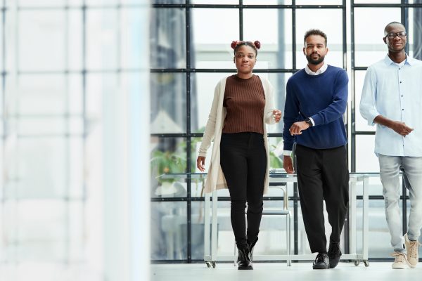 group of young business people walking through the office hall. business concept. copy of the text space